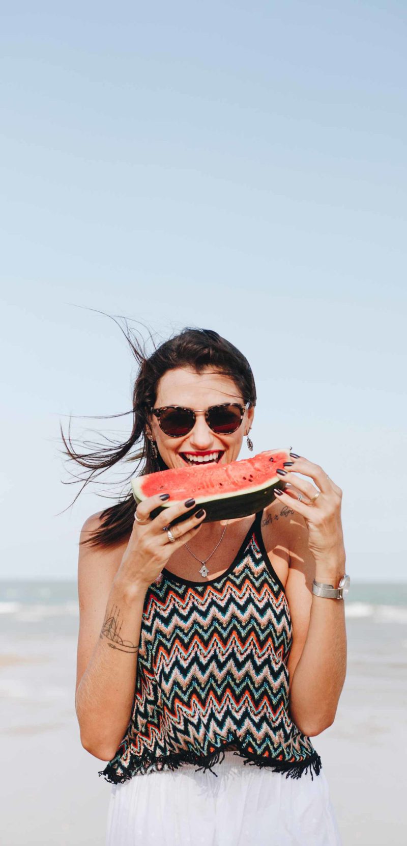 woman-eating-watermelon-at-the-beach-R2E5TKF-scaled.jpg